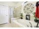 Relaxing bathroom featuring a soaking tub and a separate glass-enclosed shower for a spa-like experience at 11688 Brighton Knoll Loop, Riverview, FL 33579