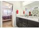 Elegant bathroom with double sinks and granite countertops, conveniently connected to the bedroom at 11688 Brighton Knoll Loop, Riverview, FL 33579