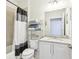 Well-lit bathroom featuring a shower, vanity, and storage shelving for a functional design at 11688 Brighton Knoll Loop, Riverview, FL 33579