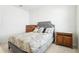 Inviting bedroom with a gray upholstered bed, decorative pillows, and wooden furniture for a comfortable retreat at 11688 Brighton Knoll Loop, Riverview, FL 33579