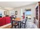 Open concept living space with views of outdoor pond, dining table with seating for four, and bookshelf at 11688 Brighton Knoll Loop, Riverview, FL 33579