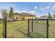Fenced community dog park with lush green grass, providing a safe space for pets to play and socialize at 11688 Brighton Knoll Loop, Riverview, FL 33579