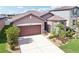 Charming home with a two-car garage, stone accents, and well-manicured landscaping at 11688 Brighton Knoll Loop, Riverview, FL 33579