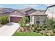 Beautiful home featuring a two-car garage, stone detailing, and lush landscaping at 11688 Brighton Knoll Loop, Riverview, FL 33579