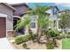 Inviting home exterior showcasing stone accents and a lushly landscaped yard with various plants and stone ground cover at 11688 Brighton Knoll Loop, Riverview, FL 33579