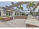 Community outdoor grill station with brick surround, granite countertops, and wood pergola, perfect for entertaining at 11688 Brighton Knoll Loop, Riverview, FL 33579