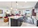 Open layout kitchen featuring granite countertops, dark cabinets, and an island with seating at 11688 Brighton Knoll Loop, Riverview, FL 33579