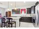 A spacious kitchen with dark wood cabinets, stainless steel appliances, and a granite countertop island with chairs at 11688 Brighton Knoll Loop, Riverview, FL 33579