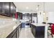 Bright kitchen featuring dark cabinetry, stainless steel appliances, granite countertops and a central island for efficient meal preparation at 11688 Brighton Knoll Loop, Riverview, FL 33579