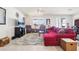 Bright living room with neutral tile flooring, comfortable red sectional, and classic leather armchairs at 11688 Brighton Knoll Loop, Riverview, FL 33579