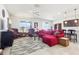 Bright living room with neutral tile flooring, comfortable red sectional, and classic leather armchairs at 11688 Brighton Knoll Loop, Riverview, FL 33579