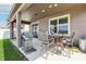 Covered patio with a grill and table, perfect for alfresco dining or relaxing outdoors in comfort at 11688 Brighton Knoll Loop, Riverview, FL 33579
