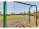 Swings at the community playground with views of the large grass field and surrounding homes at 11688 Brighton Knoll Loop, Riverview, FL 33579
