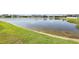 Scenic view of a pond with lush green grass in a tranquil community setting at 11688 Brighton Knoll Loop, Riverview, FL 33579