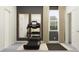 Well-lit exercise room featuring a treadmill, mirrors, and natural light, creating an ideal workout space at 11845 Sparkling Topaz Cv, Parrish, FL 34219