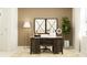 This cozy home office features a dark wood desk, beige walls, and an eye-catching accent mirror at 11845 Sparkling Topaz Cv, Parrish, FL 34219
