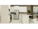 Bright, modern kitchen with stainless steel appliances, white cabinetry, and island with seating at 11845 Sparkling Topaz Cv, Parrish, FL 34219
