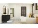 Bright bedroom features a decorative accent piece and an open doorway to an additional seating area at 11845 Sparkling Topaz Cv, Parrish, FL 34219
