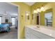 Bathroom with white vanity, framed mirror, and view into the main bedroom through the open doorway at 120 Cedarwood Cir # 120, Seminole, FL 33777