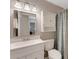Cozy bathroom with a white vanity and white fixtures, accented by a framed mirror and overhead lighting at 120 Cedarwood Cir # 120, Seminole, FL 33777