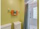 Bathroom features a shower with glass block window, light green walls, cabinet, and a towel rack at 120 Cedarwood Cir # 120, Seminole, FL 33777