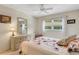 Comfortable bedroom features a floral patterned bedspread, natural light, and wooden furnishings at 120 Cedarwood Cir # 120, Seminole, FL 33777