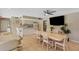 Community room with tile flooring, kitchen, dining tables, chairs, TV, and view of community area at 120 Cedarwood Cir # 120, Seminole, FL 33777