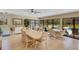 Bright community room with tile floors, tables, chairs, and views of the outdoor community areas at 120 Cedarwood Cir # 120, Seminole, FL 33777