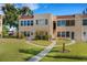 Charming condominium building with well-manicured lawn, red-tile roof, and inviting walkway at 120 Cedarwood Cir # 120, Seminole, FL 33777