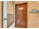 Front door of condo with welcome decorations and modern hardware, ready to welcome you home at 120 Cedarwood Cir # 120, Seminole, FL 33777