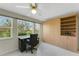 Bright home office features a built-in wall unit and a large window overlooking the exterior landscape at 120 Cedarwood Cir # 120, Seminole, FL 33777