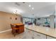 Open kitchen layout with tile flooring, an island, and a view of the dining and living areas at 120 Cedarwood Cir # 120, Seminole, FL 33777