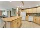 Bright kitchen with light-colored cabinetry, tiled backsplash, and an island with ample counter space at 120 Cedarwood Cir # 120, Seminole, FL 33777