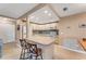 Bright kitchen with a center island, breakfast bar and modern stainless steel appliances at 120 Cedarwood Cir # 120, Seminole, FL 33777