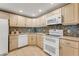 Kitchen featuring neutral-toned cabinets, tile backsplash, and stainless steel appliances at 120 Cedarwood Cir # 120, Seminole, FL 33777