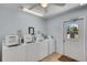 Bright laundry room features multiple white washing machines and a ceiling fan at 120 Cedarwood Cir # 120, Seminole, FL 33777