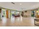 Bright, open living space with tile flooring and access to the sunroom at 120 Cedarwood Cir # 120, Seminole, FL 33777