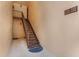 Common building access stairway with beige walls, dark metal handrail, and unit number signage at 120 Cedarwood Cir # 120, Seminole, FL 33777