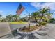 Community entrance with a DARWHO 55+ sign, American flag, and beautifully landscaped grounds at 120 Cedarwood Cir # 120, Seminole, FL 33777