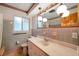 Vintage-style bathroom with pink and gray tile accents and ample counter space at 1242 Nelson St, Dunedin, FL 34698