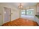 Open-concept dining area featuring wood floors and an ornate chandelier fixture at 1242 Nelson St, Dunedin, FL 34698