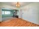 Bright dining area with hardwood floors, a chandelier, and a view of the living room at 1242 Nelson St, Dunedin, FL 34698