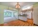 Bright kitchen with light wood floors and a view into a sunroom at 1242 Nelson St, Dunedin, FL 34698