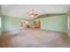 Spacious living room bathed in natural light, with carpet flooring and neutral walls at 1242 Nelson St, Dunedin, FL 34698