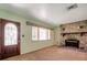 Bright living room featuring a stone fireplace, a large window, and ample space at 1242 Nelson St, Dunedin, FL 34698
