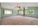 Spacious living room featuring large windows for natural light and a ceiling fan for comfort at 1242 Nelson St, Dunedin, FL 34698