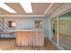 Enclosed patio featuring an outdoor bar with wood paneling with access to the house at 1242 Nelson St, Dunedin, FL 34698