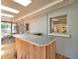 Enclosed patio featuring an outdoor bar with wood paneling, ideal for relaxing or entertaining at 1242 Nelson St, Dunedin, FL 34698