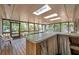 Enclosed sunroom featuring a wood floor and a countertop overlooking the yard at 1242 Nelson St, Dunedin, FL 34698