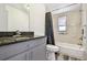 Bathroom featuring tiled shower-tub combo, gray vanity and fixtures at 1247 21St St, Sarasota, FL 34234